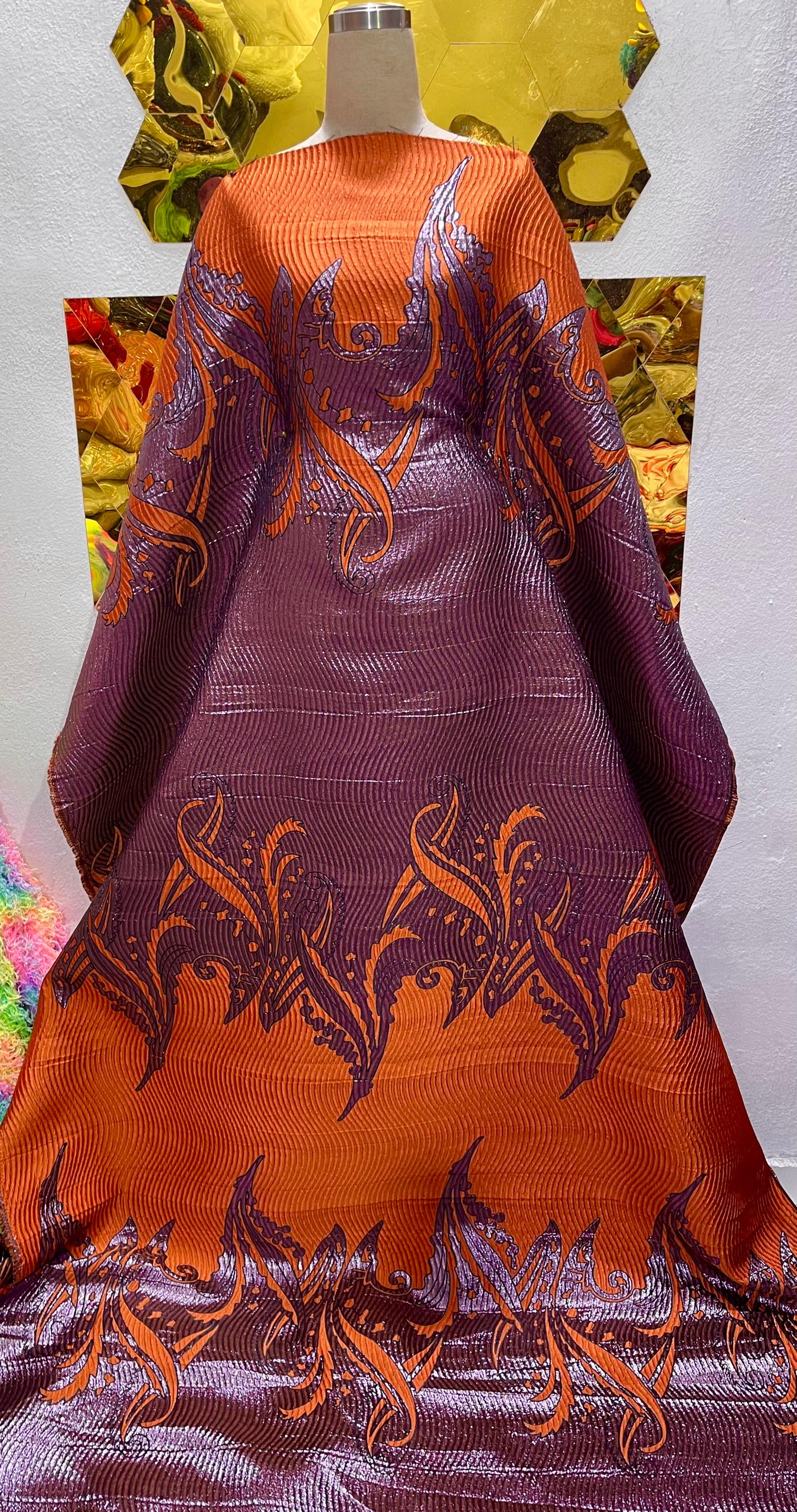 Burnt orange and plum brocade.                Selling by yards