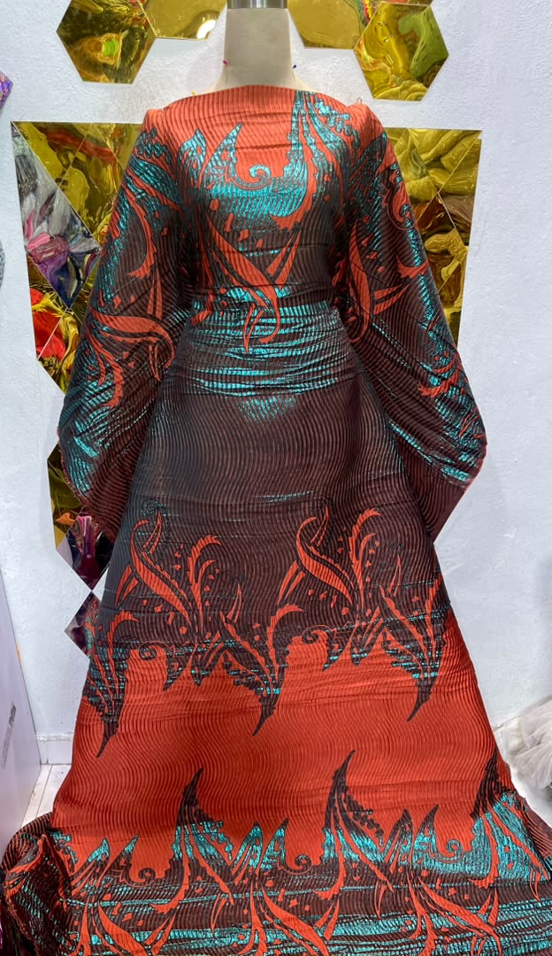 Burnt orange and teal brocade.     Selling by yards
